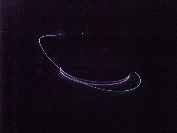 Photogragh of our Yb-doped fiber amplifier. The blight curves show the IR emission from the optical fiber.